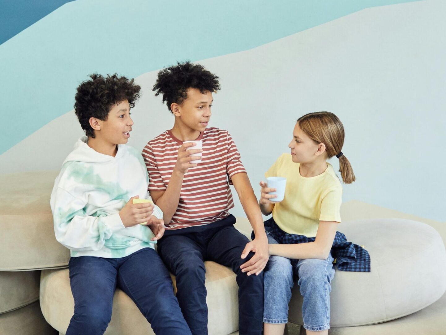 Three children chatting and smiling